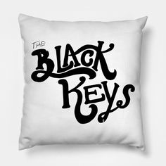 the black keys logo is shown on a white square pillow with an inscription underneath it