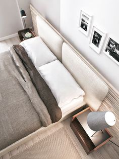 an overhead view of a bed with white sheets and pillows, next to pictures on the wall