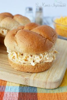 two chicken salad sandwiches on a cutting board