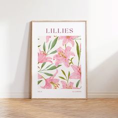 a pink flower print with the word lilies on it in front of a white wall