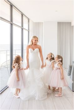 the bride and her flower girls are getting ready to walk down the aisle