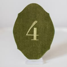 the number four is made out of green felt