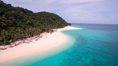 an aerial view of a tropical island with white sand and palm trees