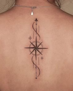 a woman with a compass tattoo on her back