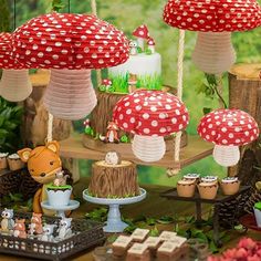 a table topped with lots of cakes covered in red and white polka dot paper lanterns