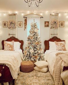 two twin beds in a bedroom decorated for christmas with lights on the ceiling and a tree