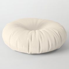 a white round pillow sitting on top of a table