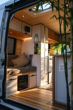 the interior of a camper van with its door open and plants growing in it