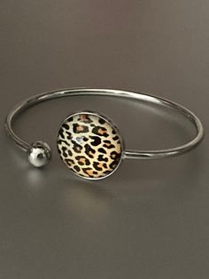 Leopard print stainless steel glass cabochon bangle bracelet    Will not tarnish lightweight to wear I have matching jewellery in this range  necklaces, rings earrings and keyrings :-) just search leopard print !!  Also in other designs Metal Bracelets Gift, Metal Bracelets As Gift, Metal Circle Bracelets As Gift, Gift Alloy Bangle, Alloy Bangle As A Gift, Trendy Stainless Steel Jewelry For Gifts, Minimalist Round Alloy Jewelry, Trendy Round Alloy Jewelry, Trendy Stainless Steel Jewelry As Fashion Accessory