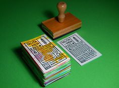 a rubber stamp sitting on top of a pile of paper next to a stack of cards