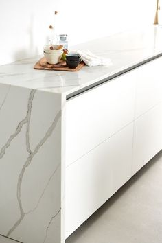 a kitchen counter with white marble on it