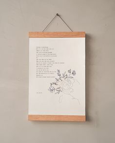 a wooden frame hanging on the wall with a poem written in cursive writing