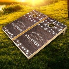 two cornhole game boards with lights on them