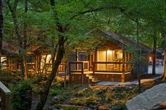 a cabin in the woods with steps leading up to it