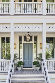 a blue front door on a white house