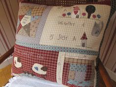 a pillow that has been made to look like a patchwork pillow with words on it