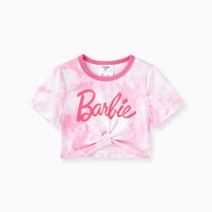 a pink tie dye shirt with the word barbie on it and a bow at the front