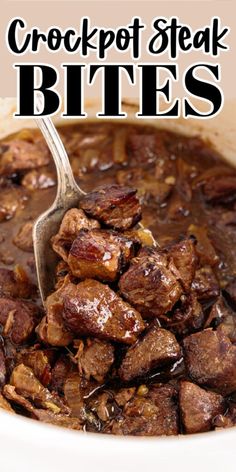 crockpot steak bites in a white bowl with a spoon sticking out of it