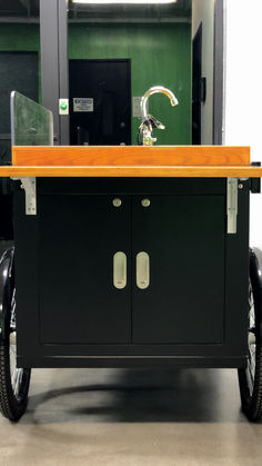 a black cart with an orange counter top