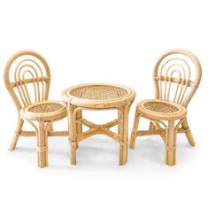 three chairs and a table made out of rattan with wickers on them