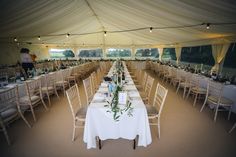 a large tent with tables and chairs set up for an event