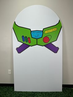 a cardboard cutout of a pair of glasses on top of a white board with green grass