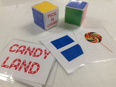 some candy land blocks and stickers on a white table with the words pick a card