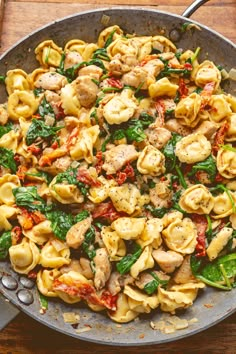 pasta with spinach and chicken in a skillet