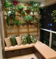 an outdoor seating area with plants on the wall