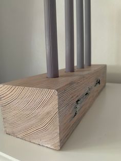 a wooden block with three candles sticking out of it