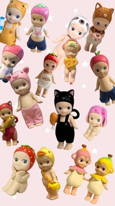 an image of many small dolls on a pink background