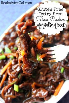 a spoon full of beef and carrots with the words gluten free dairy free slow cooker mingling beef