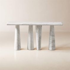 three white marble benches sitting next to each other