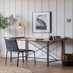 a table with two chairs and a potted plant on it in front of a white wall