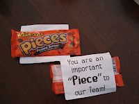 two pieces of candy sitting on top of a table next to a sign that says, you are an important piece to our team