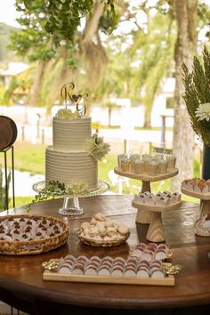 a table topped with lots of desserts and cakes