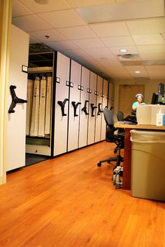 an empty room with several lockers and chairs