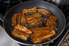 some fried food is cooking in a pan on the stove