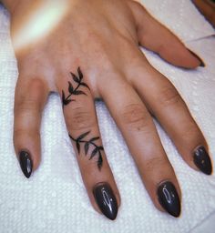 a woman's hand with a small tattoo on it