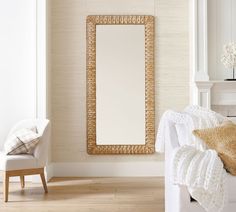 a white bench and mirror in a room