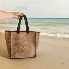 Embrace the summer vibes with our Handmade Straw Beach Bag, featuring elegant black striped.  Crafted with care, it is designed to be carried comfortably on the shoulder or by hand. Material: Eco-Friendly High-Quality paper yarn.  👙🏖️Perfect for beach outings, shopping trips, or daily use. Upgrade your summer style with this versatile and chic beach bag.  You can easily fit your personal items such as a towel, sunscreen, bikini, book, and magazine.  Get yours today and enjoy the perfect blend Large Capacity Square Beach Bag For Beach Season, Rectangular Sand Beach Bag For Summer, Rectangular Sand-colored Beach Bag For Summer, Summer Rectangular Sand Beach Bag, Black Bucket Straw Bag For Vacation, Square Travel Bags For Summer, Square Summer Travel Bags, Chic Black Shoulder Bag For Beach Season, Square Straw Bag For Beach Vacation