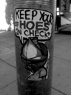 a sticker on the side of a pole that says keep your shoes in check