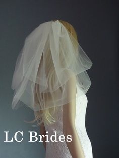 a mannequin wearing a wedding dress and veil with the words l c brides written on it