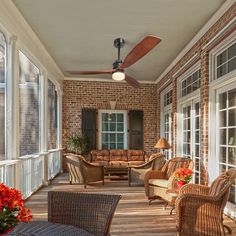 a porch with wicker furniture and large windows