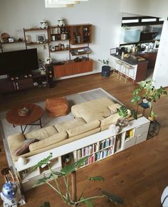 a living room filled with furniture and a flat screen tv on top of a wooden floor