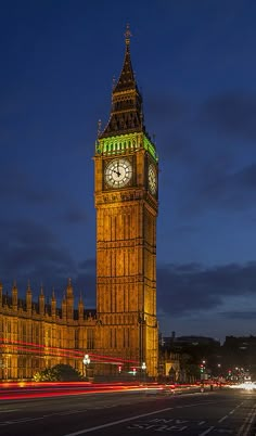 the big ben clock tower towering over the city of london, england at night time