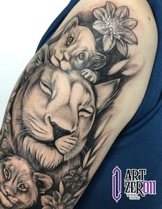 a woman's arm with a lion and flower tattoo design on her left shoulder