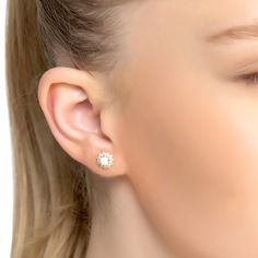 Say hello to your latest accessory obsession! These stunning Opal and Flower Stud Earrings Gold are every modern girl's dream. Crafted from 925 sterling silver dipped in 18ct gold, these dainty earrings feature a pretty opal set within a dainty flower setting that is sure to make you stand out in the crowd.  And if that isn't enough, these earrings are adorned with sparkling cubic zirconia that guarantee you will be looking good no matter the occasion. Whether you need an extra something special Flower Setting, Stud Earrings Gold, Flower Stud Earrings, Flower Stud, Flower Earrings Studs, Flower Studs, Dainty Earrings, White Opal, Gold Earrings Studs