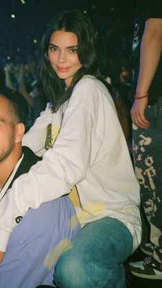 a man sitting next to a woman at a concert