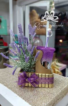 purple flowers in a basket on top of a table